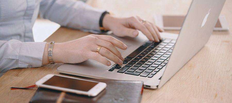 Freelance writer typing on her laptop